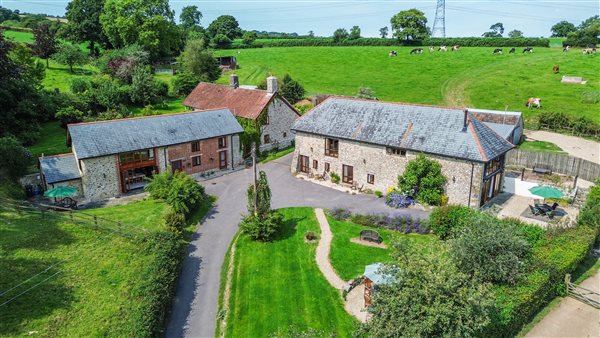 From the air all three holiday cottages, cows and farmhouse